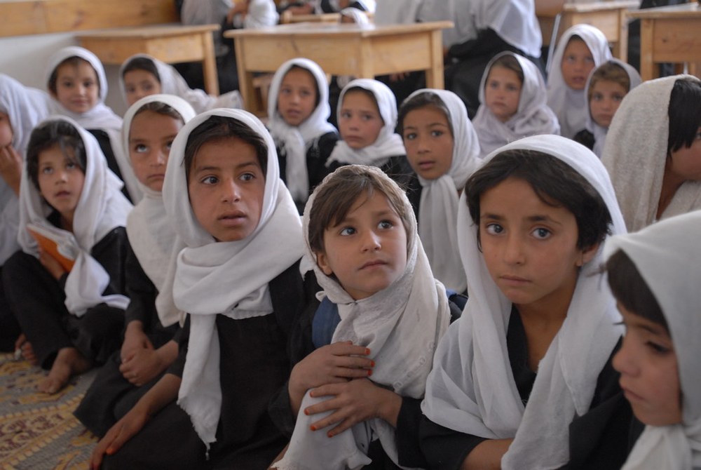 Afghan schoolgirls in white headscarves in a classroom